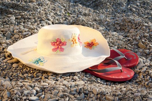 hat and flip-flops on the stones outdoors shooting