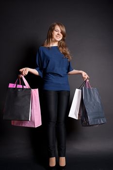 A happy girl with shopping bags after studio photography