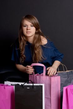 A happy girl with shopping bags after studio photography