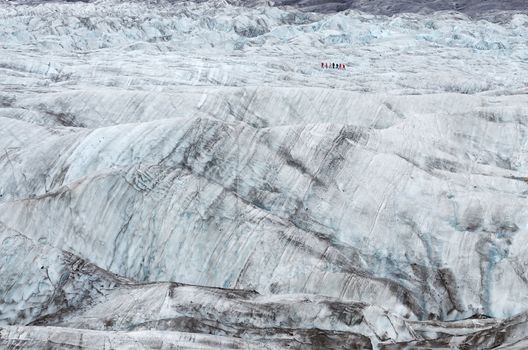 Vatnajokull glacier wild ice trekking, group of small people, Iceland