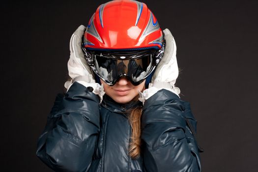 A girl in a ski helmet and goggles
