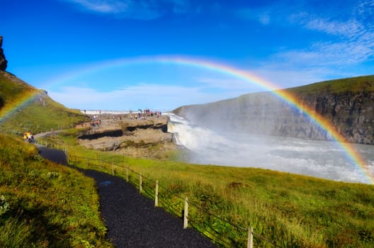 Gullfoss wild waterfall, strong running water and rainbow, daylight view, Iceland