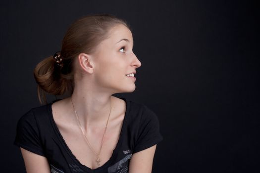 Smiling girl sitting in profil  studio photography