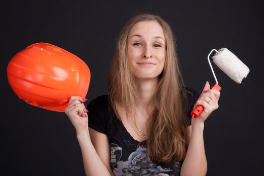 the girl is holding an orange helmet and cushion