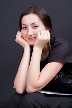 portrait of a beautiful girl on a dark background studio photography
