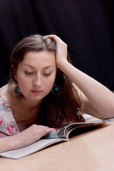 girl reading a magazine on the floor, studio photography