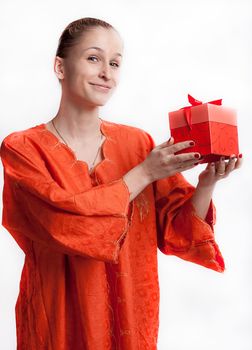 The girl in orange dress with a gift studio photography