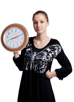 The girl with the big clock in the hands of studio shooting