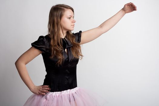 Young girl in a pink skirt on a light background