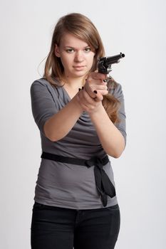 girl with a gun on a light background