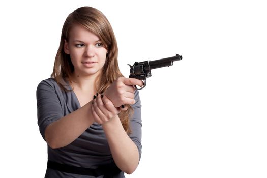 Girl with a gun in the hands of studio shooting