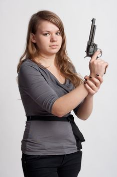 girl with a gun on a light background