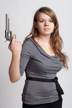 girl with a gun on a light background