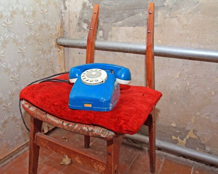 old telephone on broken chair