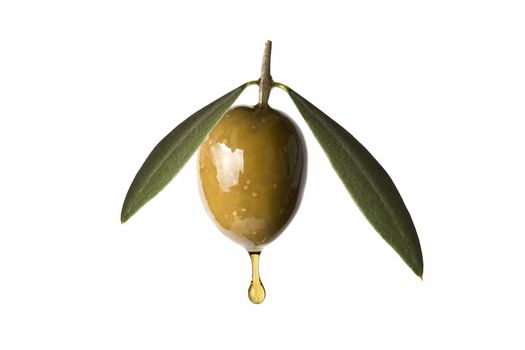 A drop of olive oil falling from one green olive isolated on a white background