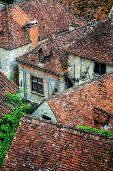 Old village detail of houses with brick roofs and windows, France