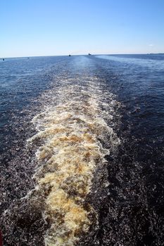 trace from motorboat on big river