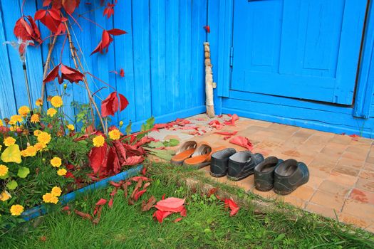 aging footwear on porch of the rural building