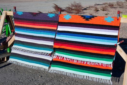 Indian rug on display on the side of the road