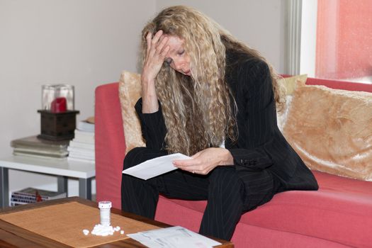 woman worried about bills and debt and foreclosure and thinking about taking pills