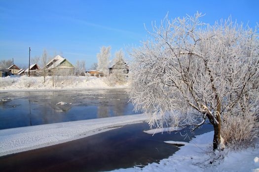 winter ice on river near villages