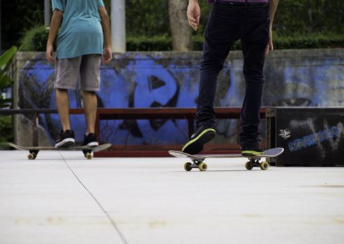 feet and skates riding on a skateboards in the park 