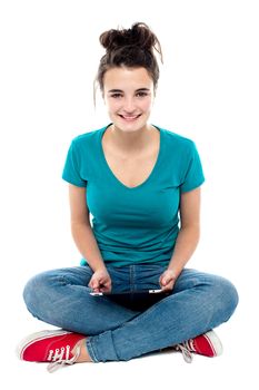 Charming teenager posing with tablet pc in hands. Studio shot