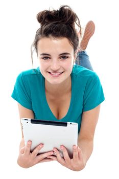 Glamorous pretty girl posing with wireless tablet. Isolated on white