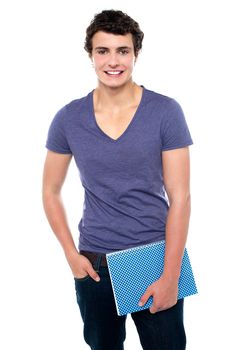 Stylish teenager posing casually in denims isolated against white background