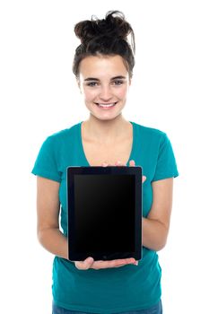 Casual teenager showing newly launched tablet device to the camera