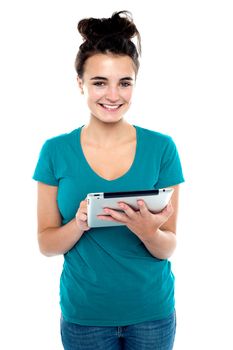 Pretty young brunette using wireless tablet device isolated against white background
