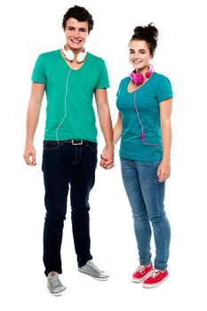 We share love for music. Full length portrait of charming couple holding hands