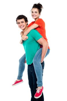 Portrait of a handsome young man giving a piggyback ride to his girlfriend - Indoor