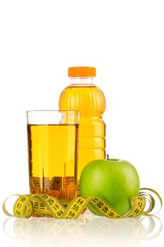 Apple juice in plastic bottle and glass with a measure tape isolated on white background