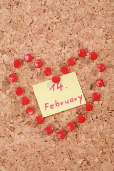 a valentine heart made of thumb tacks on a corkboard...........