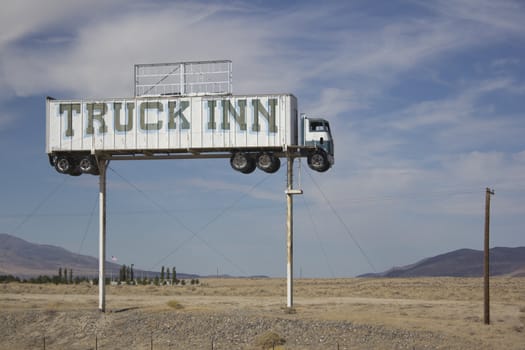 Old abandoned semi truck sign in the middle of the desert. The sign is from an old Inn that was demolished over 50 years ago.