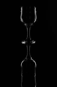 Wine glasses on a black background with reflection on glass