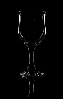 Wine glass on a black background with reflection on glass