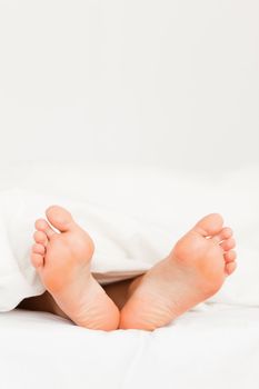 Close up of feet in a bed