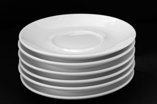 White plates isolated on black background