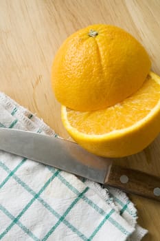 knife and half pieces of orange cut