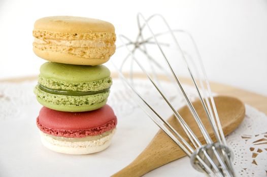 stack of colorful macarons with kitchenware