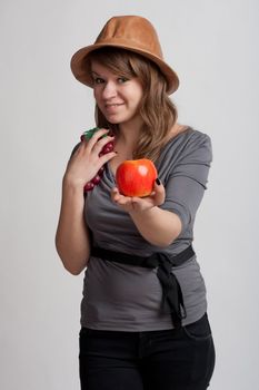 girl on a light background offers apple