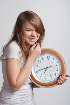 beautiful girl with a big clock in his hands