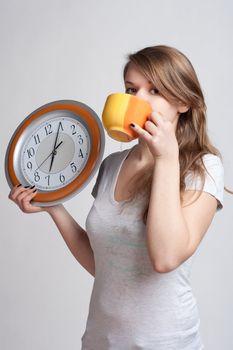 girl holding in one hand and watch while the other cup