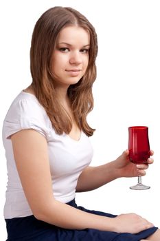 A girl in a bright red T-shirt and a glass sitting on a white background