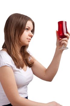 A girl in a bright red T-shirt and a glass sitting on a white background