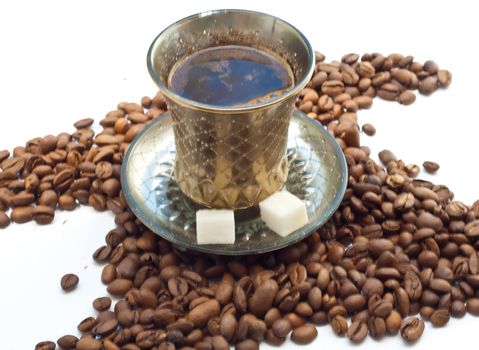 A cup of coffee is on the coffee beans on white background