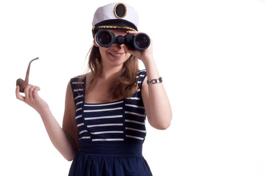 A girl in a sailor cap holding a pipe for smoking and looking through binoculars on a white background