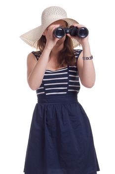 A girl in a big straw hat looking through binoculars on a white background